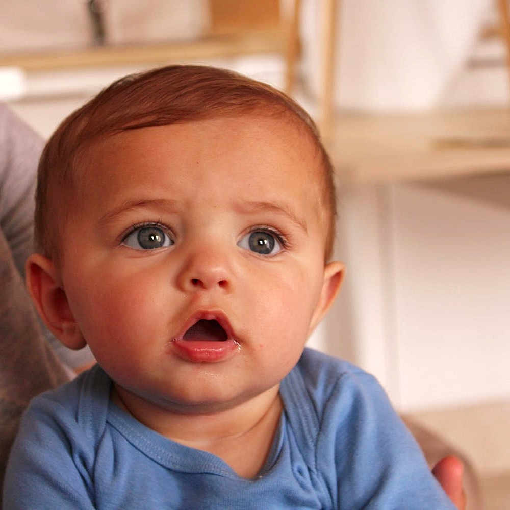Asaph participe au concours pour gagner de l'argent avec cette photo : baby, blue_clothing, child, closeup, curious, cute, expression, eyes, face, hair, head, human, indoor, infant, mouth_open, person, portrait, seated, skin, young
