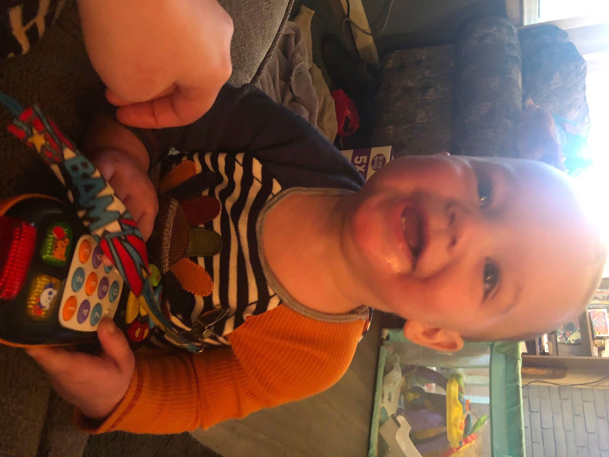 Malcolm is registered to the contest to win money with this photo: cheek, child, cool, ear, elbow, eye, finger, forehead, fun, hairstyle, happy, mouth, neck, nose, orange, people, person, skin, smile, thumb