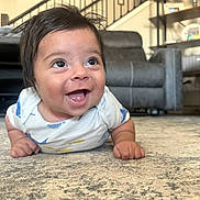 Asher joined the competition — help win amazing prizes! baby, smiling, happy, infant, carpet, indoor, living_room, furniture, couch, shelf, person, child, cute, toddler, clothing, home, expression, face, eyes, hands