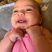 Jazzlyn joined the competition — help win amazing prizes! baby, child, smile, laughing, pink_clothing, hands, face, blanket, bunny_pattern, infant, cute, happy, skin, indoors, portrait, young_child, fist, cozy, lying_down, closeup