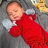 Jazzlyn is registered to the contest to win money with this photo: baby, infant, red_clothing, mittens, blanket, soft_texture, sleepwear, lying_down, indoors, cute, newborn, face, head, skin, person, young_child, child, cozy, comfort, resting