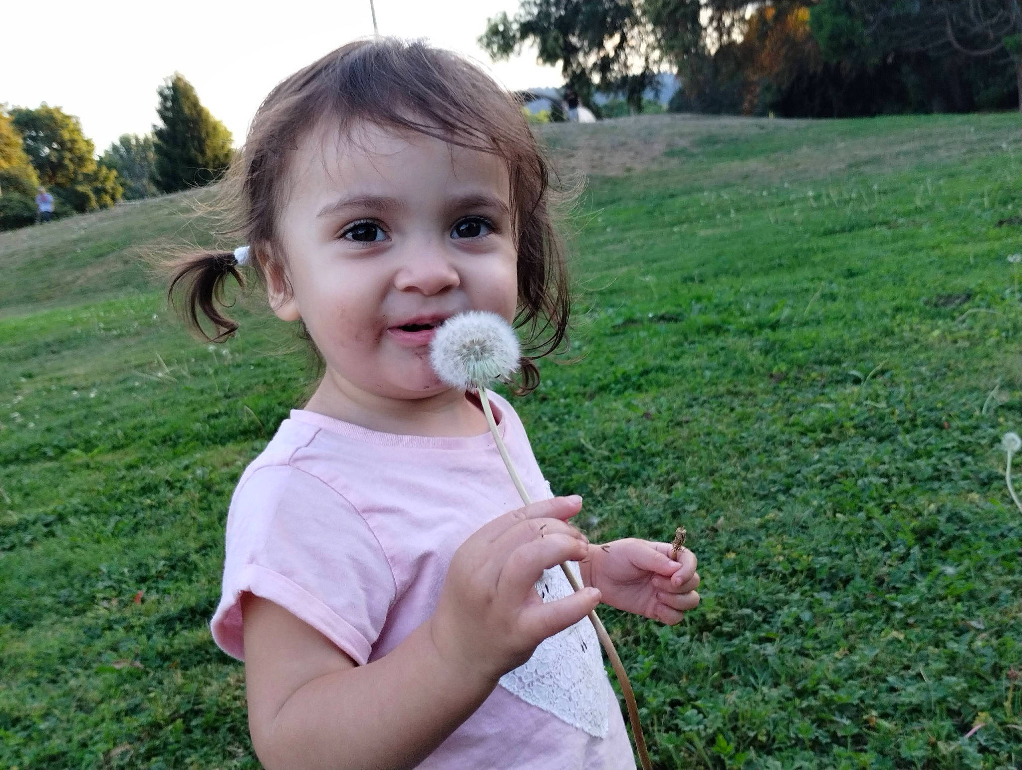 Jolene is registered to the contest to win money with this photo: baby_toddler_clothing, blond, child, fruit, fun, garden, gesture, grass, groundcover, hair, happy, joy, lawn, leaf, nose, people_in_nature, person, plant, sky, smile