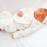 Oaklynn joined the competition — help win amazing prizes! newborn, baby, sleeping, pajamas, white_clothing, headband, bow, floral_pattern, infant, resting, soft_texture, cozy, blanket, cute, peaceful, child, portrait, indoors, small_hands, small_feet