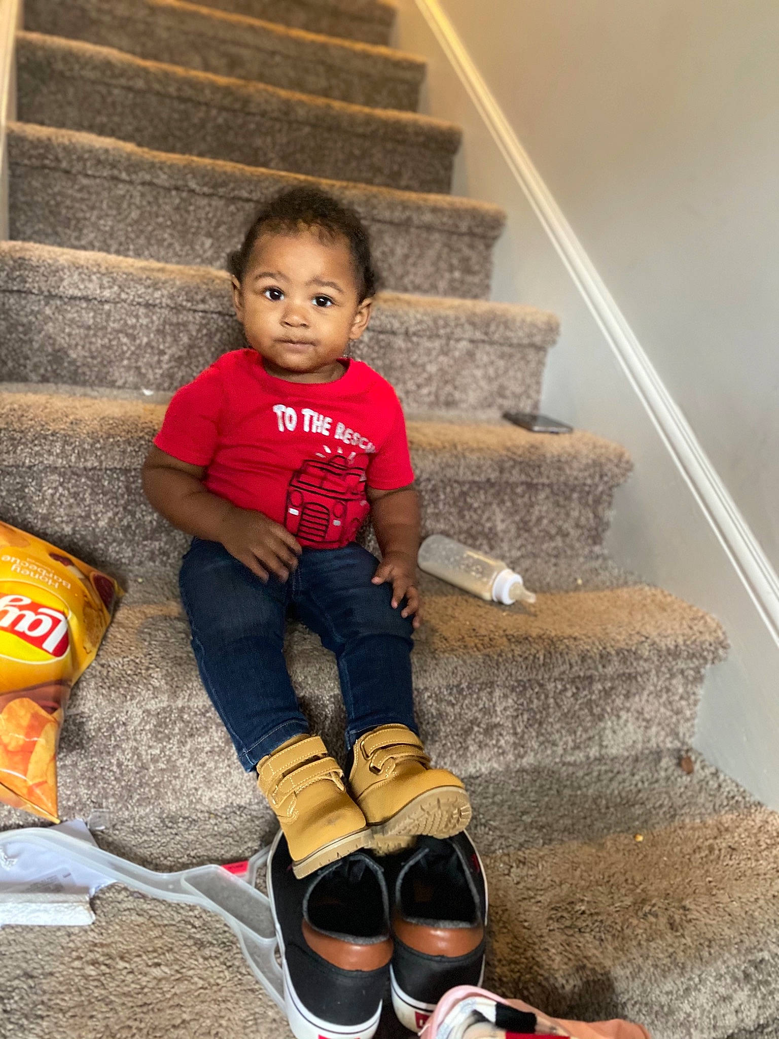 Larry is registered to the contest to win money with this photo: child, floor, flooring, fun, happy, human_body, human_leg, knee, leg, leisure, person, shoe, sitting, sleeve, sneakers, sock, stairs, thigh, toddler, white