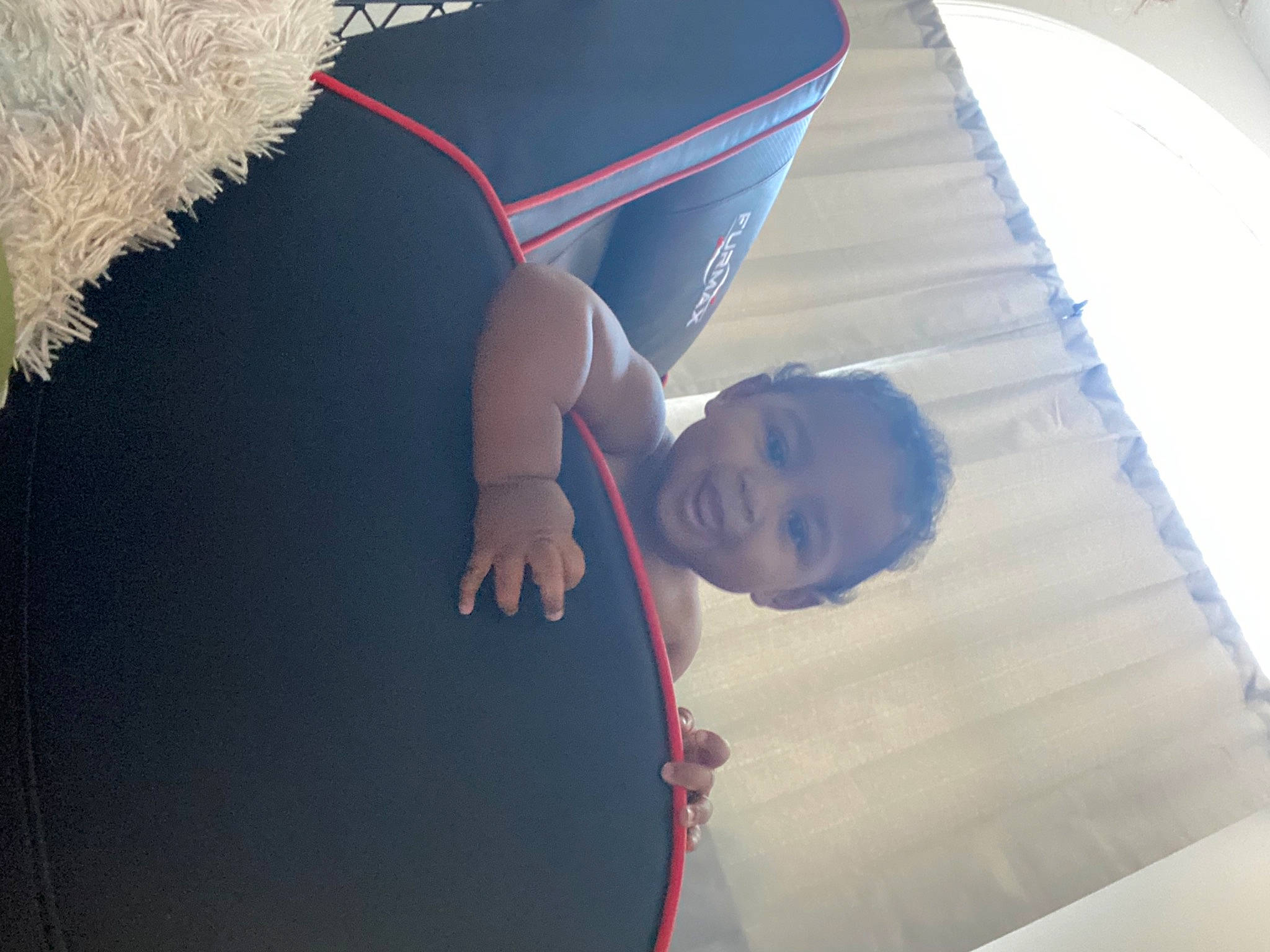 Larry is registered to the contest to win money with this photo: ceiling, child, elbow, fashion_accessory, flooring, fun, gesture, grass, happy, leisure, pattern, person, room, shade, shadow, sitting, t_shirt, textile, tints_and_shades, toddler