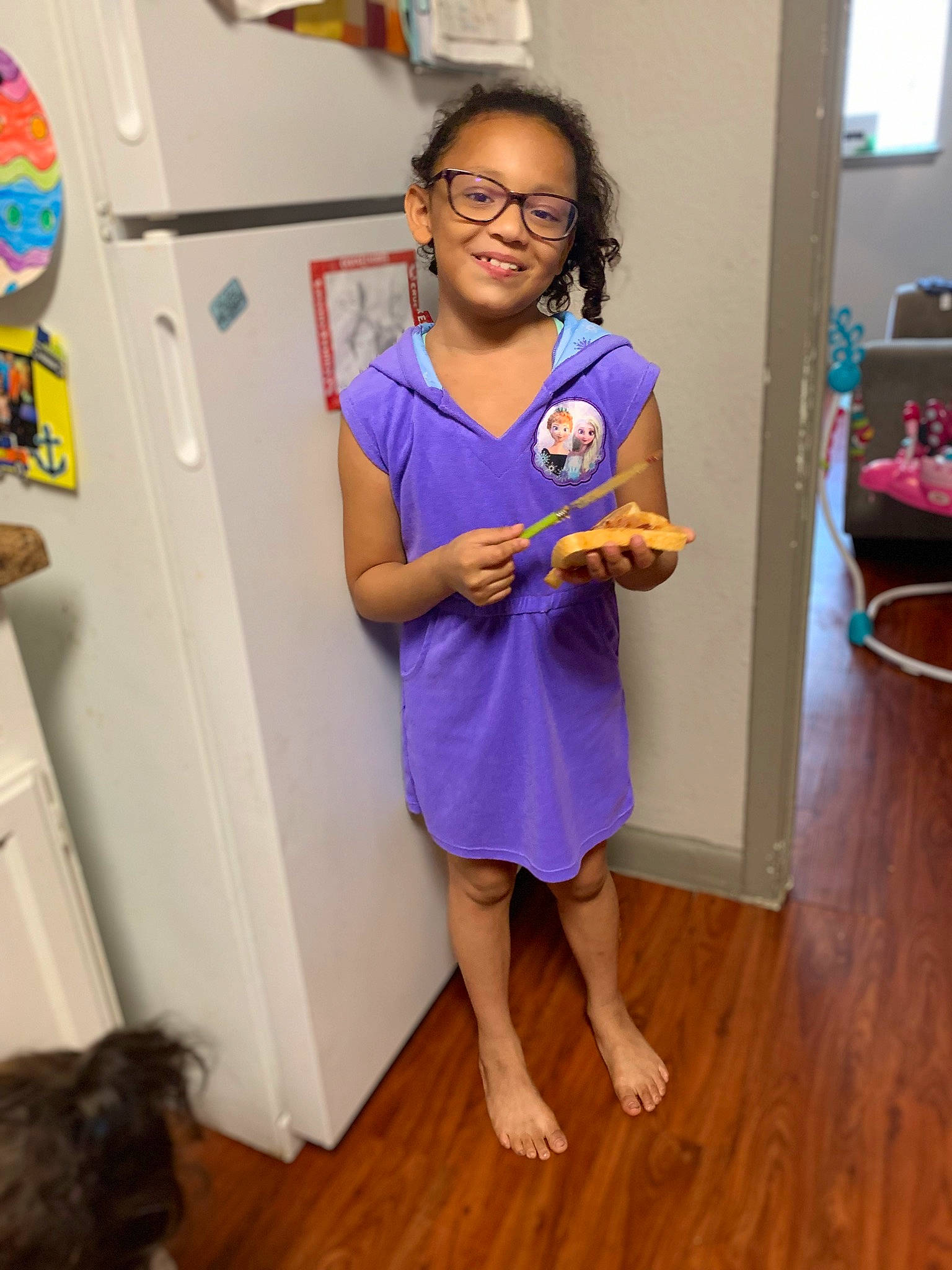 Izabella is registered to the contest to win money with this photo: child, dress, electric_blue, eyewear, floor, flooring, fun, glasses, happy, hardwood, joint, joy, laminate_flooring, person, purple, shoulder, sleeve, smile, standing, t_shirt
