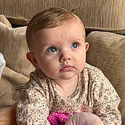 Navie Grace is registered to the contest to win money with this photo: baby, infant, child, portrait, blue_eyes, curious_gaze, couch, cushion, plush_toy, stuffed_animal, patterned_shirt, long_sleeve, hand, hair, pigtails, indoor, close_up, soft_lighting, neutral_background, sitting