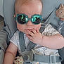 baby, child, sunglasses, car_seat, toy, giraffe, hand, clothing, reflection, person, seatbelt, cute, infant, indoor, childcare, accessory, face, cute_baby, baby_girl, baby_boy