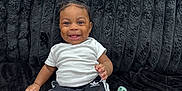 Kaycen joined the competition — help win amazing prizes! baby, child, smiling, sitting, indoor, couch, black_couch, white_shirt, black_shorts, adidas, pacifier, barefoot, happy, cute, portrait, infant, furniture, plush, person, home