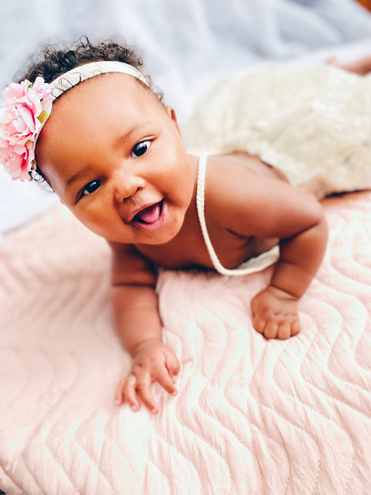 Kalaya is registered to the contest to win money with this photo: arm, baby, baby_toddler_clothing, child, close_up, comfort, eye, finger, flash_photography, flooring, happy, head, human_body, iris, person, pink, product, skin, smile, textile