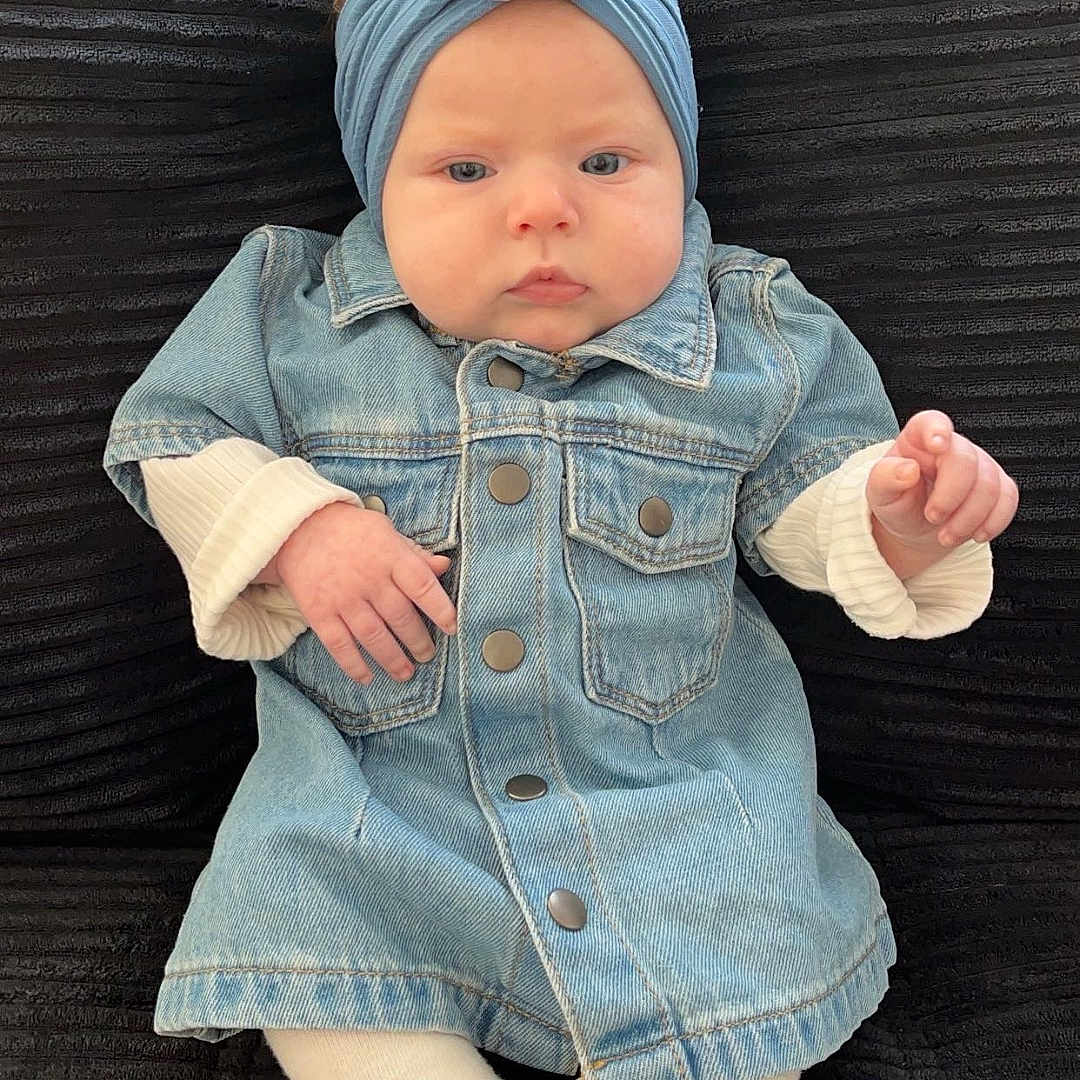 Zayli participe au concours pour gagner de l'argent avec cette photo : adorable, apparel, baby, black_background, casual, child, cushion, cute, denim_jacket, expressionless, fashion, flower, headband, indoor, infant, portrait, seated, small_hands, soft_lighting, white_tights