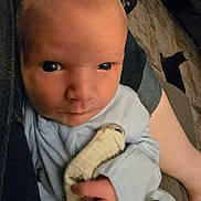 Wyatt is registered to the contest to win money with this photo: baby, newborn, infant, face, hand, blanket, clothing, person, indoor, carpet, arm, skin, cute, young, child, portrait, holding, soft, cozy, expression