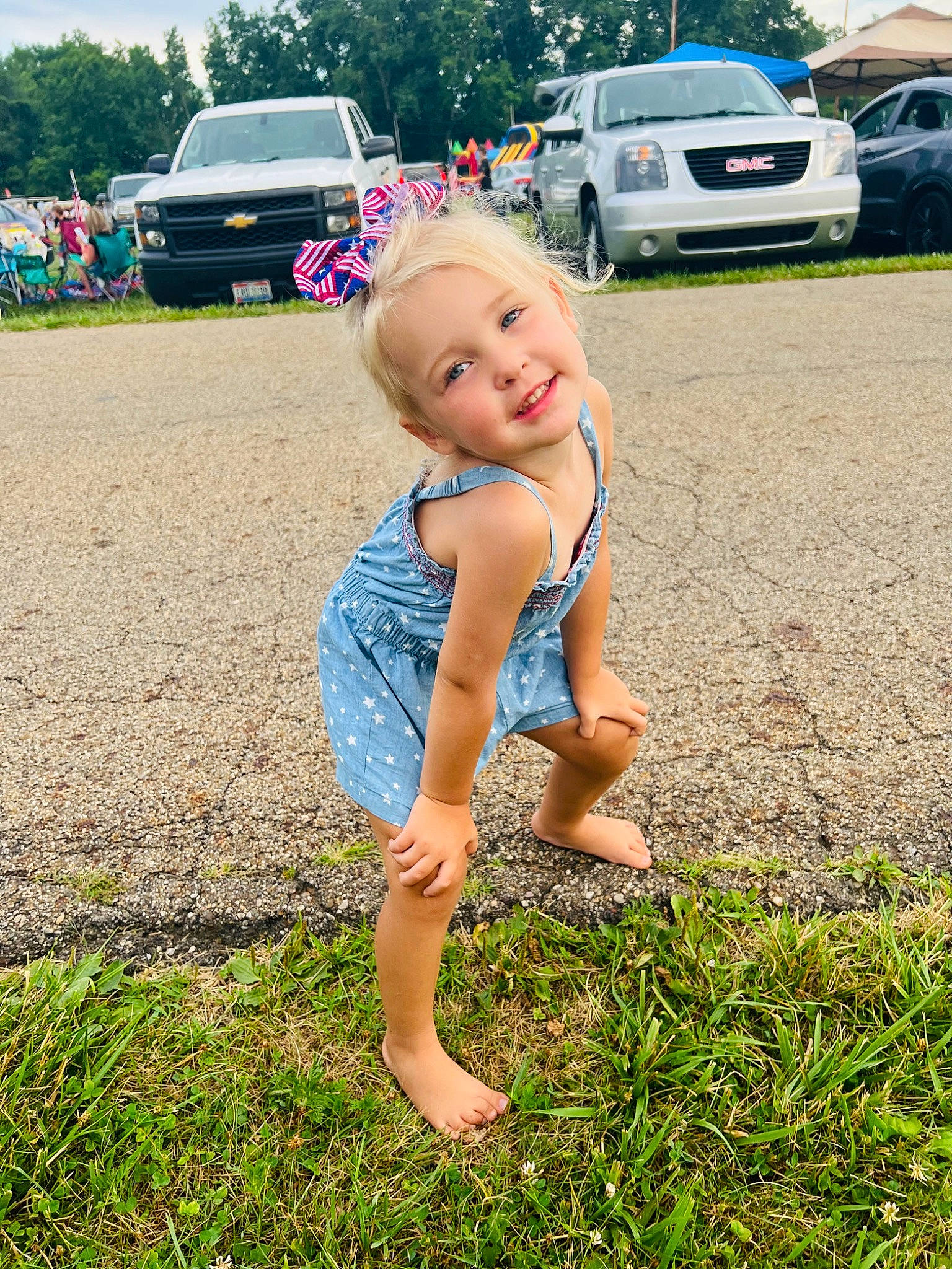 Ryleigh is registered to the contest to win money with this photo: automotive_exterior, barefoot, bumper, car, foot, grass, happy, human_leg, joy, lawn, leg, leisure, motor_vehicle, people_in_nature, person, plant, sandal, summer, tire, toddler