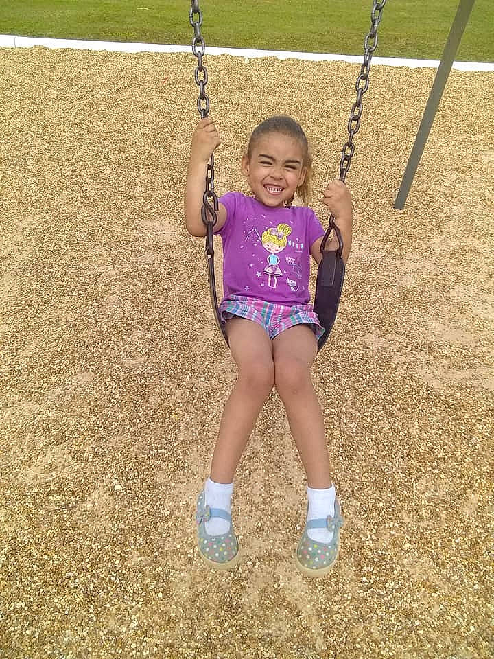 Marissa is registered to the contest to win money with this photo: child, fun, happy, human_settlement, joy, outdoor_play_equipment, person, play, playground, public_space, recreation, smile, swing, toddler