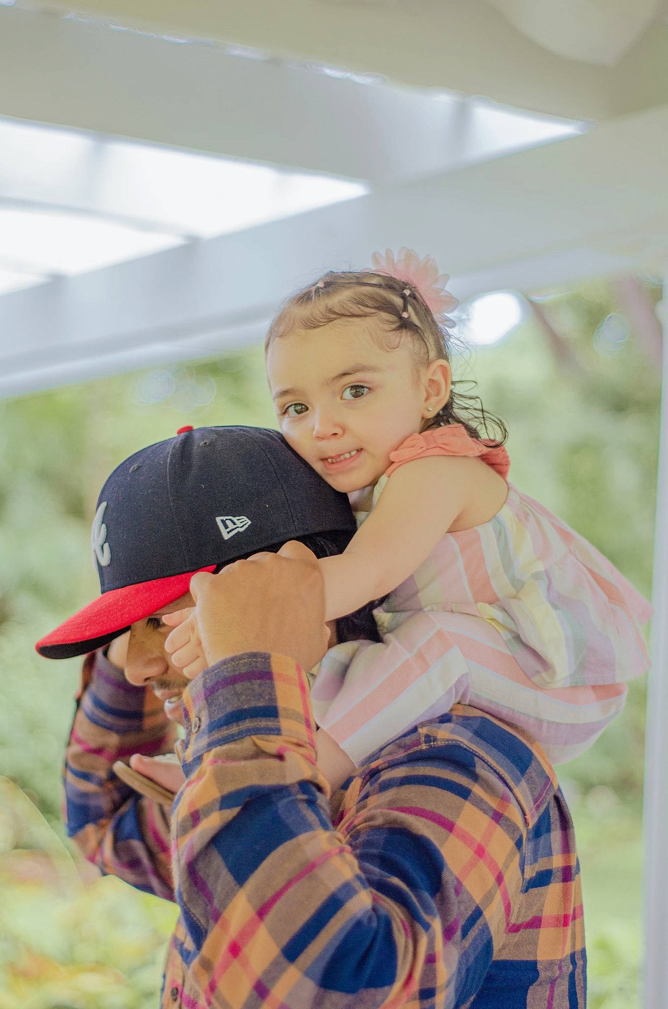 Elianni is registered to the contest to win money with this photo: baseball_cap, cap, child, fawn, flash_photography, fun, fur, grass, happy, leisure, pattern, person, plaid, play, portrait_photography, recreation, sitting, tartan, toddler, toy