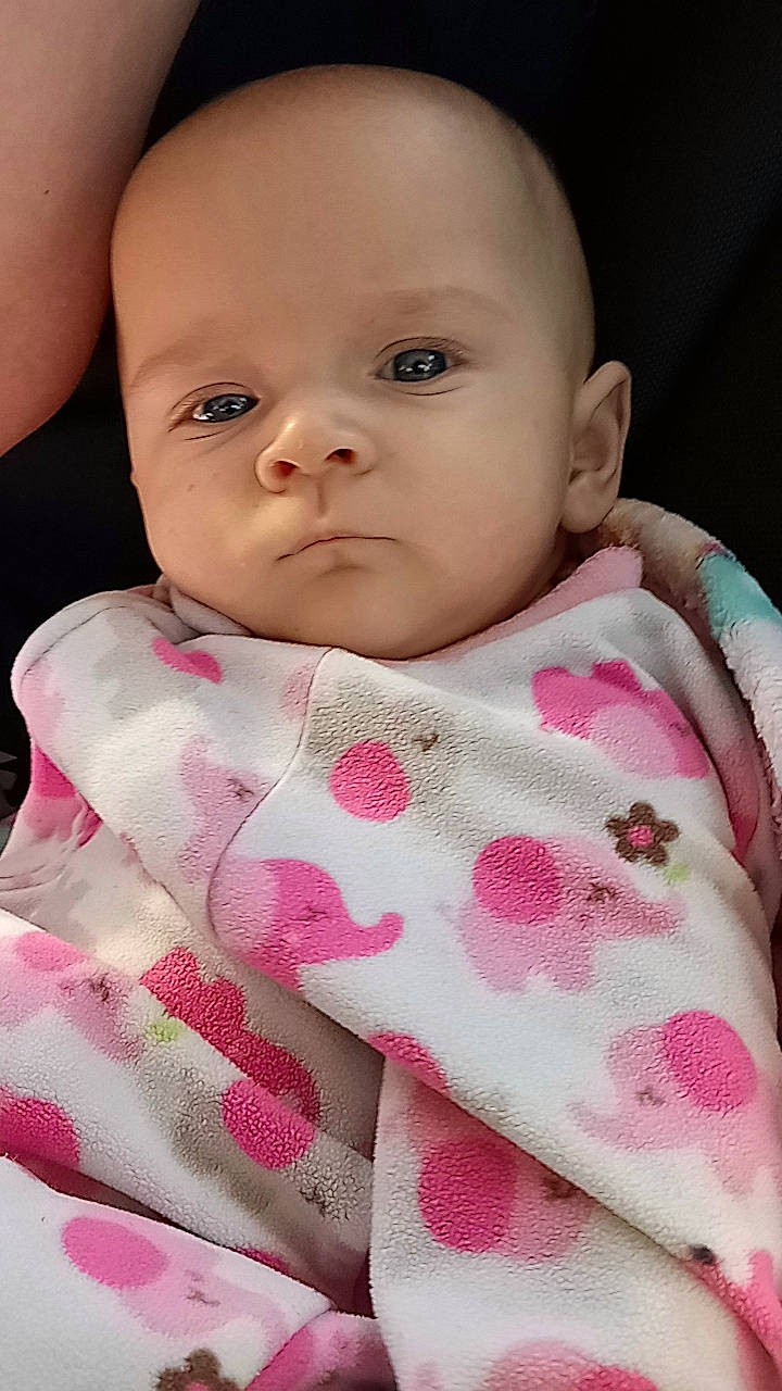 Serenity is registered to the contest to win money with this photo: baby, baby_toddler_clothing, beauty, bib, cheek, child, collar, comfort, eyelash, iris, linens, lip, magenta, neck, pattern, person, pink, skin, sleeve, textile