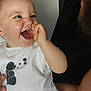 baby, child, smile, laugh, happy, adult, face, hand, white_shirt, patterned_pants, indoor, person, cute, joyful, closeup, interaction, family, love, parent, expression