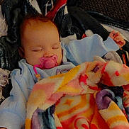 Ty'Lianna joined the competition — help win amazing prizes! baby, blanket, pacifier, sleeping, infant, cozy, soft, clothing, colorful, resting, child, indoors, comfort, cute, warm, fabric, person, head, hand, texture