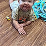 baby, child, smiling, floor, wooden_floor, blanket, pacifier, toddler, indoor, clothing, face, happy, lying_down, diaper, cute, infant, hand, expression, portrait, skin