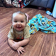 Eastyn joined the competition — help win amazing prizes! baby, child, floor, wood, blanket, tshirt, smile, happy, indoors, bottle, toy, couch, feet, arm, hand, face, expression, home, colorful, cozy