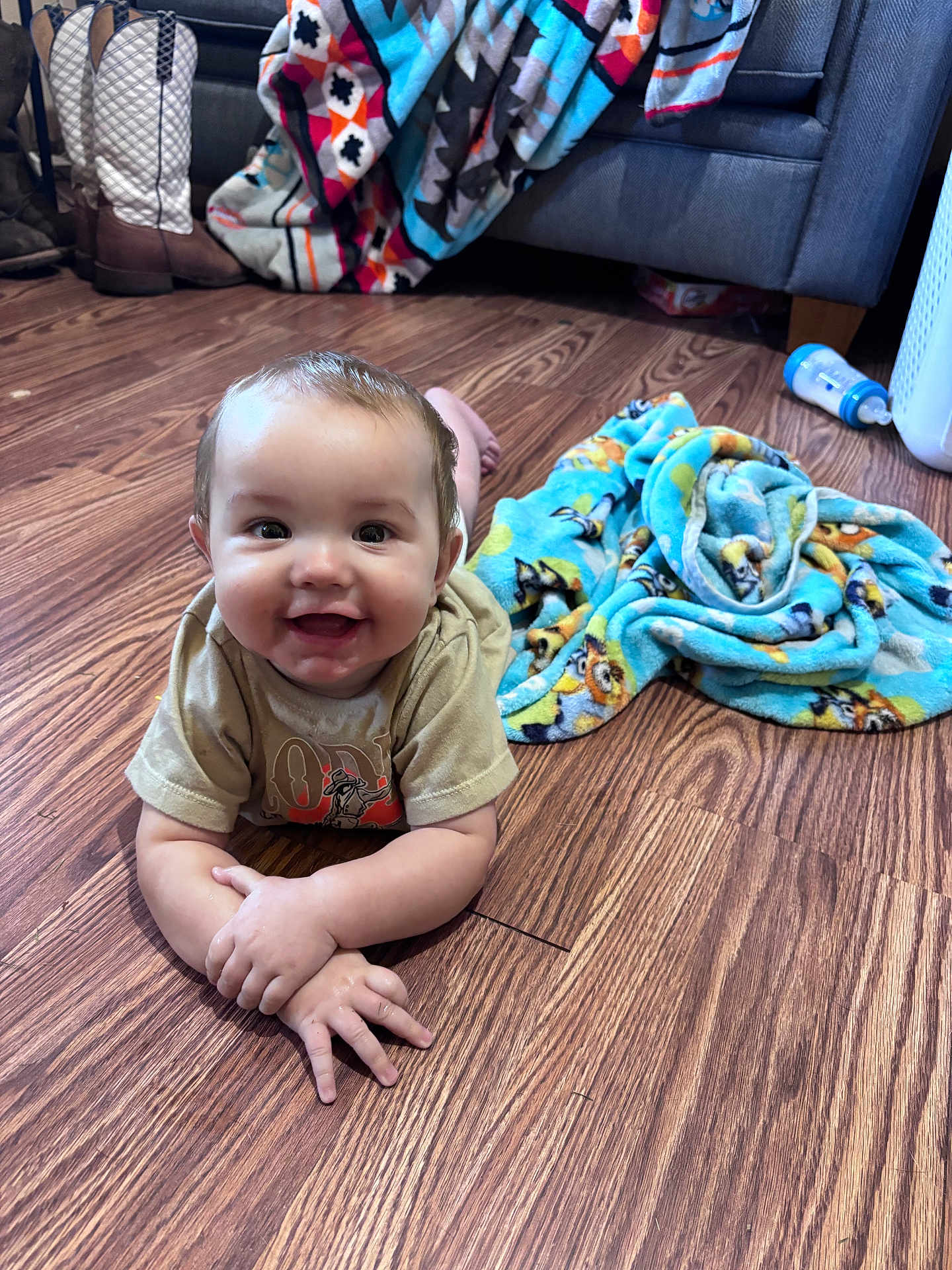 Eastyn joined the competition — help win amazing prizes! baby, child, floor, wood, blanket, tshirt, smile, happy, indoors, bottle, toy, couch, feet, arm, hand, face, expression, home, colorful, cozy