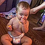 baby, diaper, snack, floor, wooden_floor, indoor, child, sitting, barefoot, person, legs, laundry_basket, furniture, home, casual, food, cute, plump, young_child, toddler
