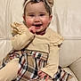 Eloïse participe au concours pour gagner de l'argent avec cette photo : baby, child, smiling, girl, headband, bow, plaid, skirt, beige, outfit, couch, leather, sitting, happy, cute, indoors, person, portrait, hand, furniture