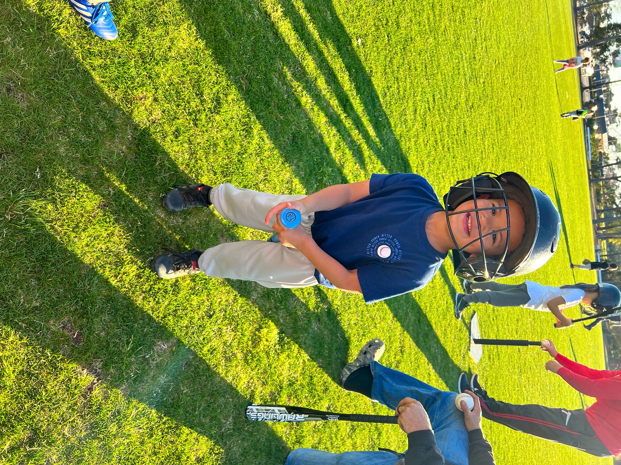 Blake is registered to the contest to win money with this photo: artificial_turf, electric_blue, flooring, fun, grass, grassland, happy, headwear, human_leg, lawn, leisure, line, people_in_nature, person, plant, recreation, shadow, shorts, sneakers, spring