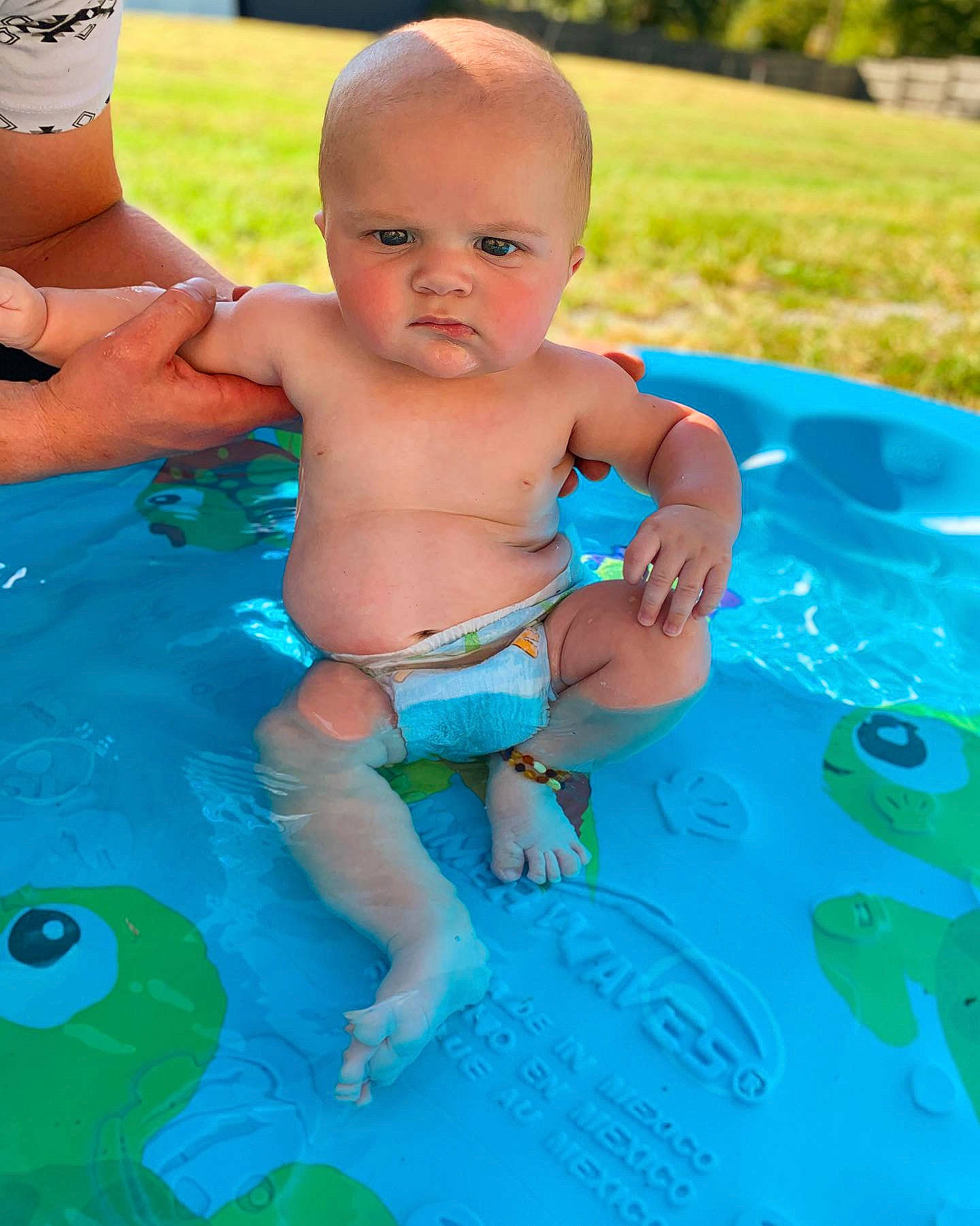 Aryan is registered to the contest to win money with this photo: aqua, baby, baby_bathing, baby_products, child, diaper, fun, grass, leisure, person, play, product, recreation, smile, summer, toddler, vacation, water