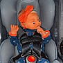 baby, car_seat, graco, headband, onesie, sleeping, infant, child, safety_harness, orange, blue, floral_pattern, cute, peaceful, indoor, seat, person, toddler, face, hand