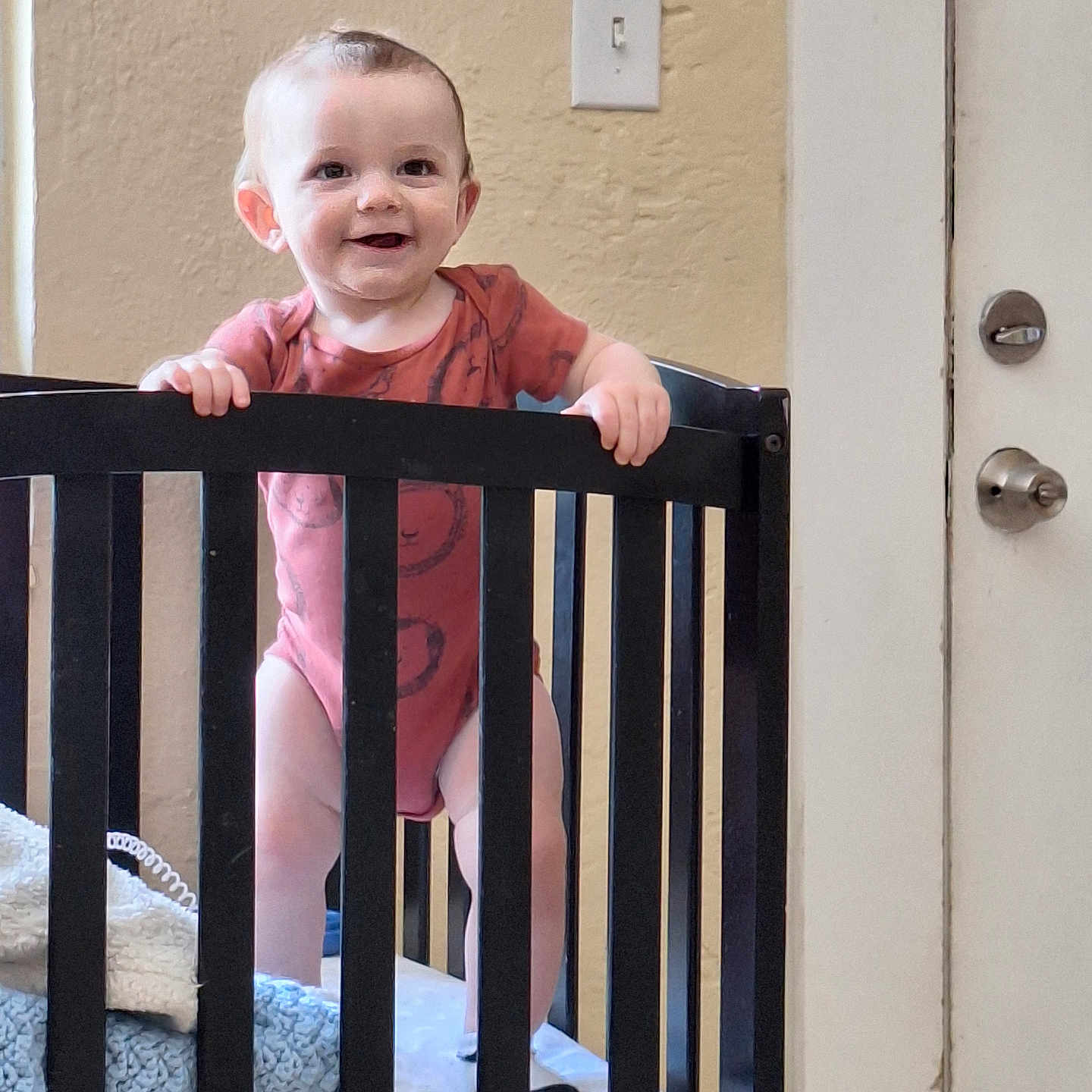 Kaiden is registered to the contest to win money with this photo: baby, bed, bodypart, crib, face, finger, furniture, hand, handrail, head, homedecor, indoors, infantbed, nursery, person, photography, portrait, railing, room, standing