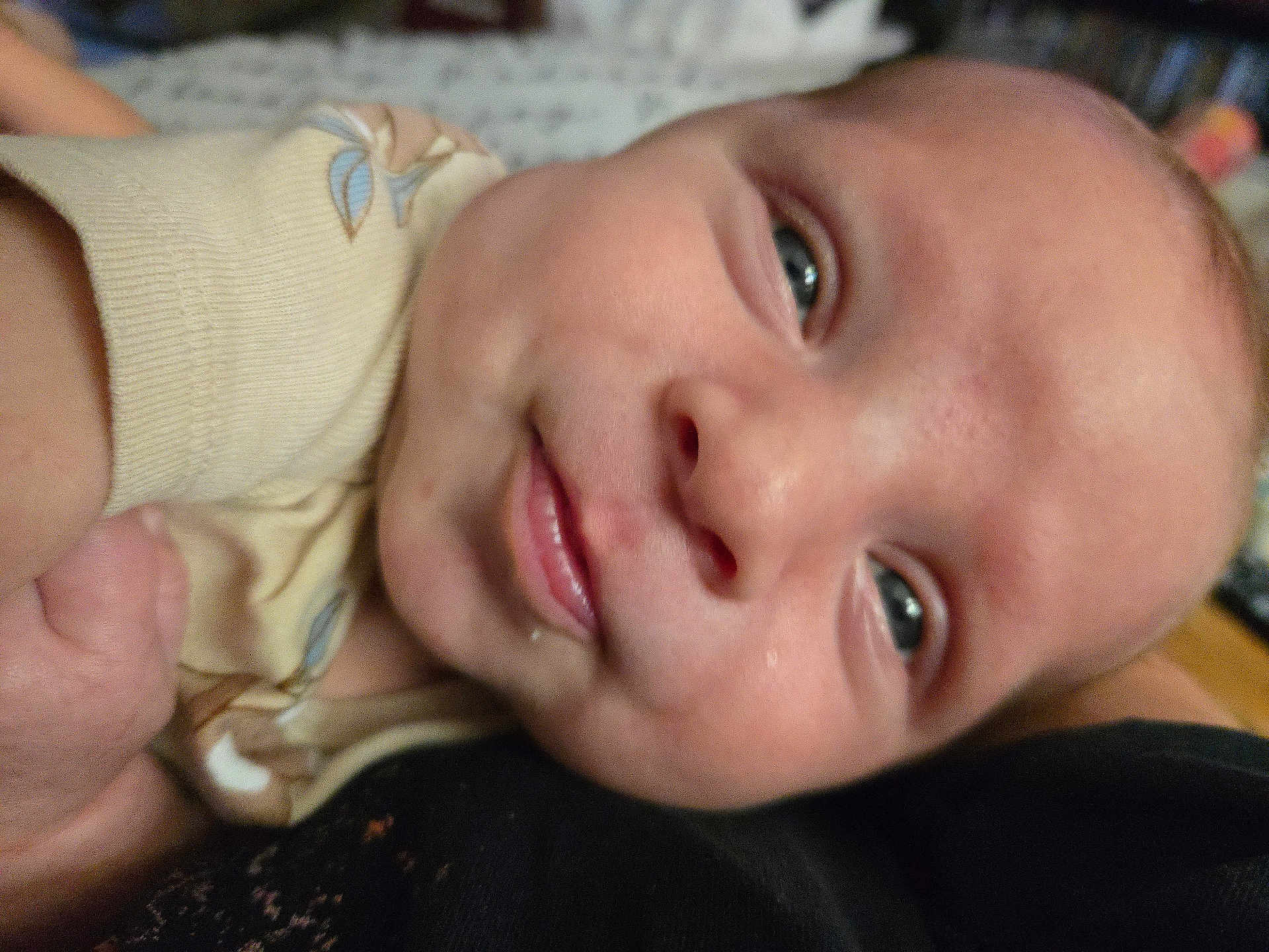 Rhett is registered to the contest to win money with this photo: baby, close_up, face, smile, infant, child, eyes, skin, expression, cute, young, portrait, person, apparel, hand, comfort, indoors, soft, head, cheek