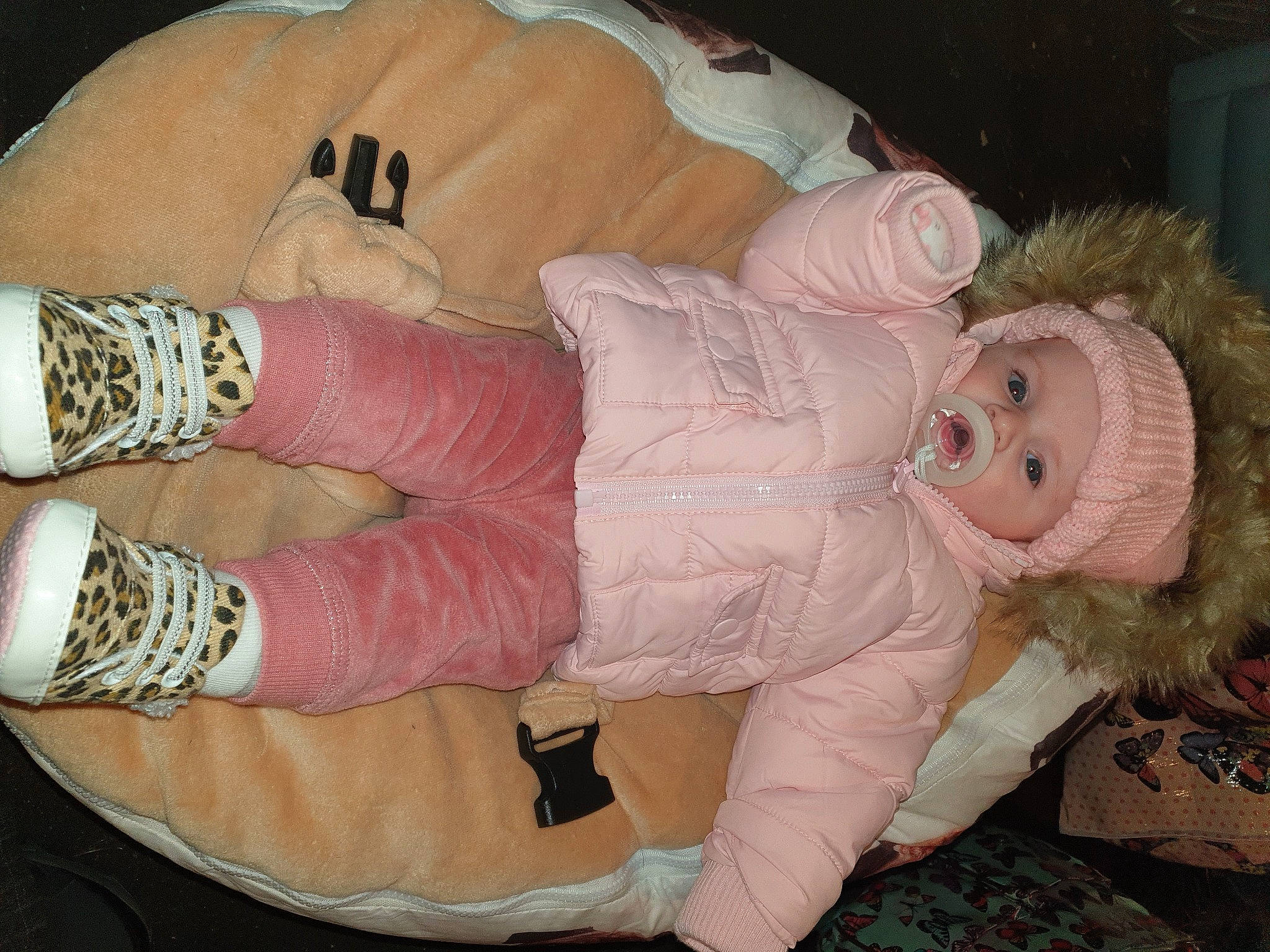 Darcy is registered to the contest to win money with this photo: body_jewelry, child, comfort, eye, finger, foot, gesture, headgear, headwear, human_body, human_leg, mouth, nail, pattern, person, pink, skin, smile, textile, thigh