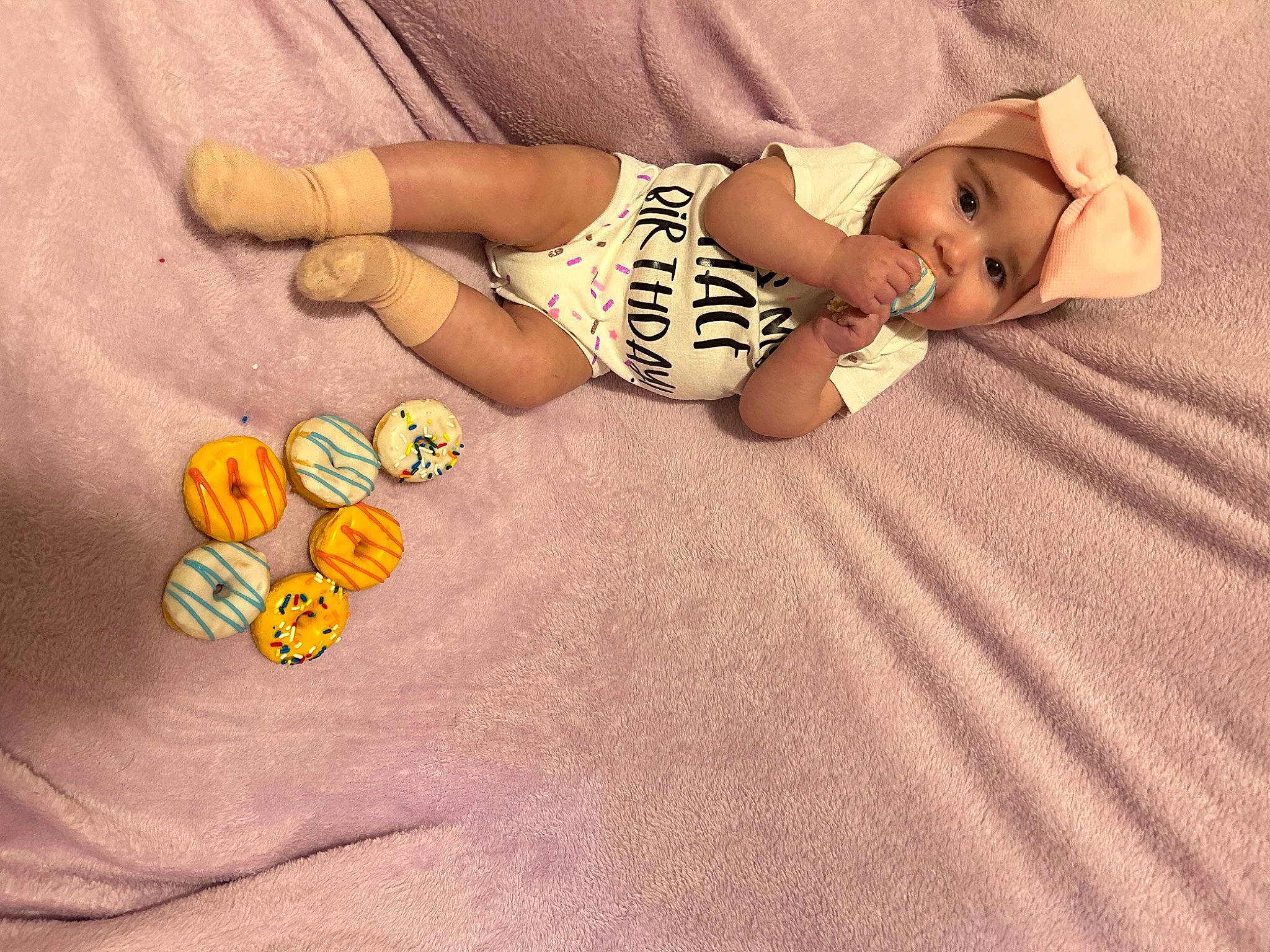 Kamryn is registered to the contest to win money with this photo: baby, barefoot, comfort, finger, flooring, foot, hand, headwear, human_body, knee, leg, mammal, people_in_nature, person, skin, textile, thigh, thumb, toddler, toy