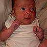 Scarlett is registered to the contest to win money with this photo: baby, infant, child, portrait, lying_down, bed, bedding, white_onesie, wide_eyes, face, hands, feet, toes, indoors, home, close_up, looking_at_camera, alert, cozy, photography
