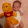 Scarlett is registered to the contest to win money with this photo: newborn, baby, infant, child, portrait, lying_down, pink_blanket, stuffed_animal, teddy_bear, winnie_the_pooh, plush_toy, onesie, wide_eyes, surprised, indoors, bed, nursery, soft_blanket, close_up, family_photo