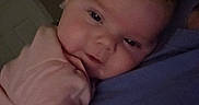 Aurora is registered to the contest to win money with this photo: baby, child, person, face, resting, close_up, indoor, soft_light, cuddling, sleepy, pink_clothing, human, portrait, infant, head, arm, warm, comfort, skin, young