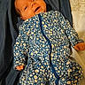 baby, infant, onesie, blue, floral_pattern, bed, bedding, blanket, clothing, cute, face, hands, lying_down, newborn, person, portrait, sleepwear, soft, toddler, warm