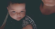 Aurora is registered to the contest to win money with this photo: baby, child, person, adult, face, portrait, smile, indoor, pillow, floral, clothing, black_shirt, skin, head, lying_down, cuddle, family, closeup, expression, cozy