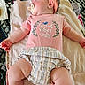 baby, sleeping, pacifier, pink_headband, pink_shirt, striped_shorts, towel, metal_table, outdoor, infant, child, cute, peaceful, relaxed, skin, hand, leg, clothing, person, portrait