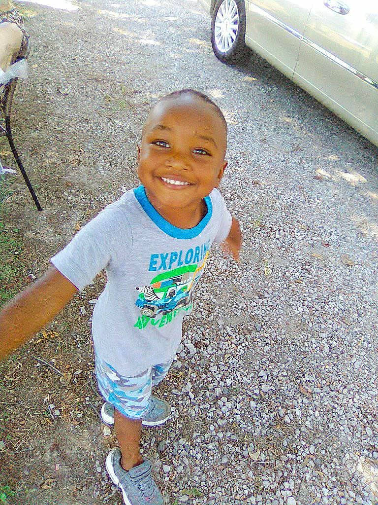 Collin is registered to the contest to win money with this photo: child, face, facial_expression, fun, grass, happy, joy, people, person, plant, play, smile, summer, t_shirt, toddler, tree, vacation, vehicle, water