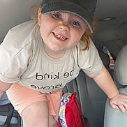 Gracelynne joined the competition — help win amazing prizes! child, smiling, cap, baseball_cap, tshirt, backpack, car_interior, car_seat, seat, red_backpack, freckles, ginger_hair, smile, teeth, portrait, happy, candid, indoor, person, shorts