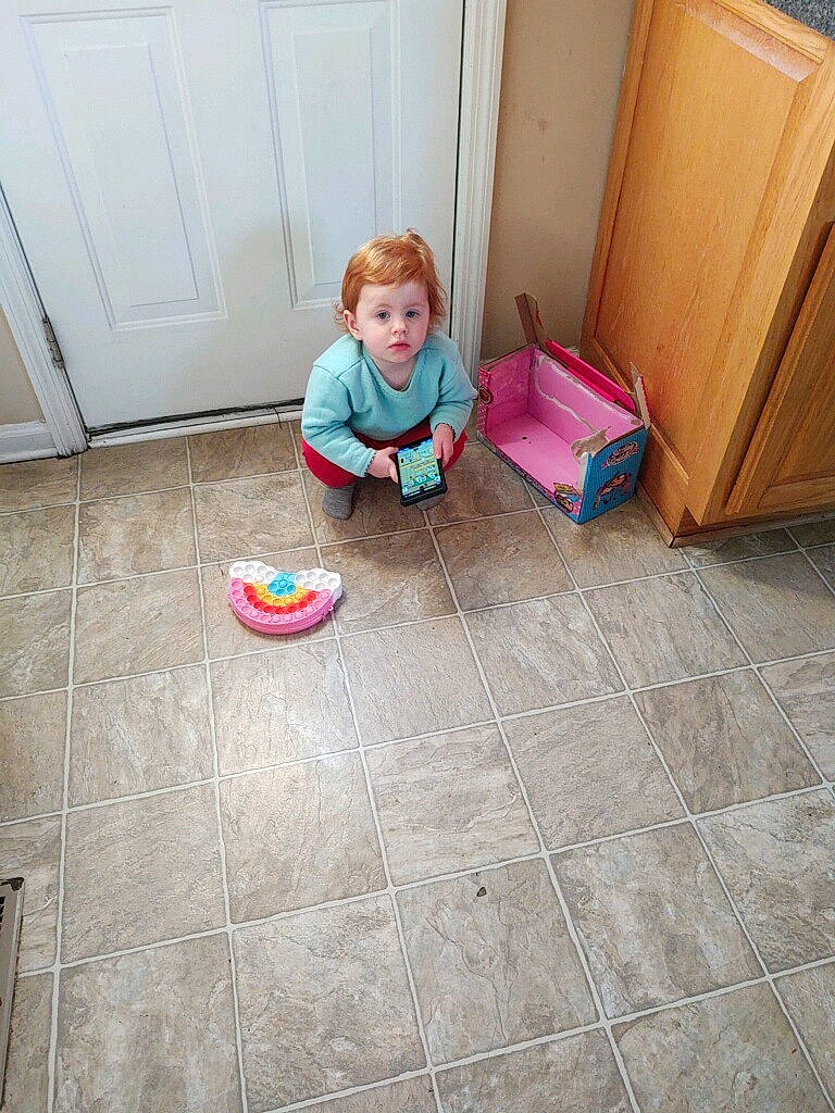 Gracelynne joined the competition — help win amazing prizes! baby, cabinetry, child, comfort, door, drawer, floor, flooring, hardwood, human_leg, laminate_flooring, leg, person, play, room, sitting, toddler, varnish, wood, wood_flooring