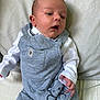 Archie joined the competition — help win amazing prizes! baby, infant, child, overalls, grey_clothing, white_shirt, cute, lying_down, cushion, soft, indoors, portrait, small_hands, toddler, sleepwear, wood_background, peaceful, curious, human, face