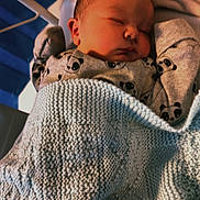 Archie joined the competition — help win amazing prizes! baby, newborn, sleeping, blanket, crib, panda_pattern, clothing, infant, bed, soft_light, peaceful, cute, indoors, person, knitted_blanket, cozy, rest, portrait, young_child, sleep