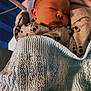 baby, newborn, sleeping, blanket, crib, panda_pattern, clothing, infant, bed, soft_light, peaceful, cute, indoors, person, knitted_blanket, cozy, rest, portrait, young_child, sleep