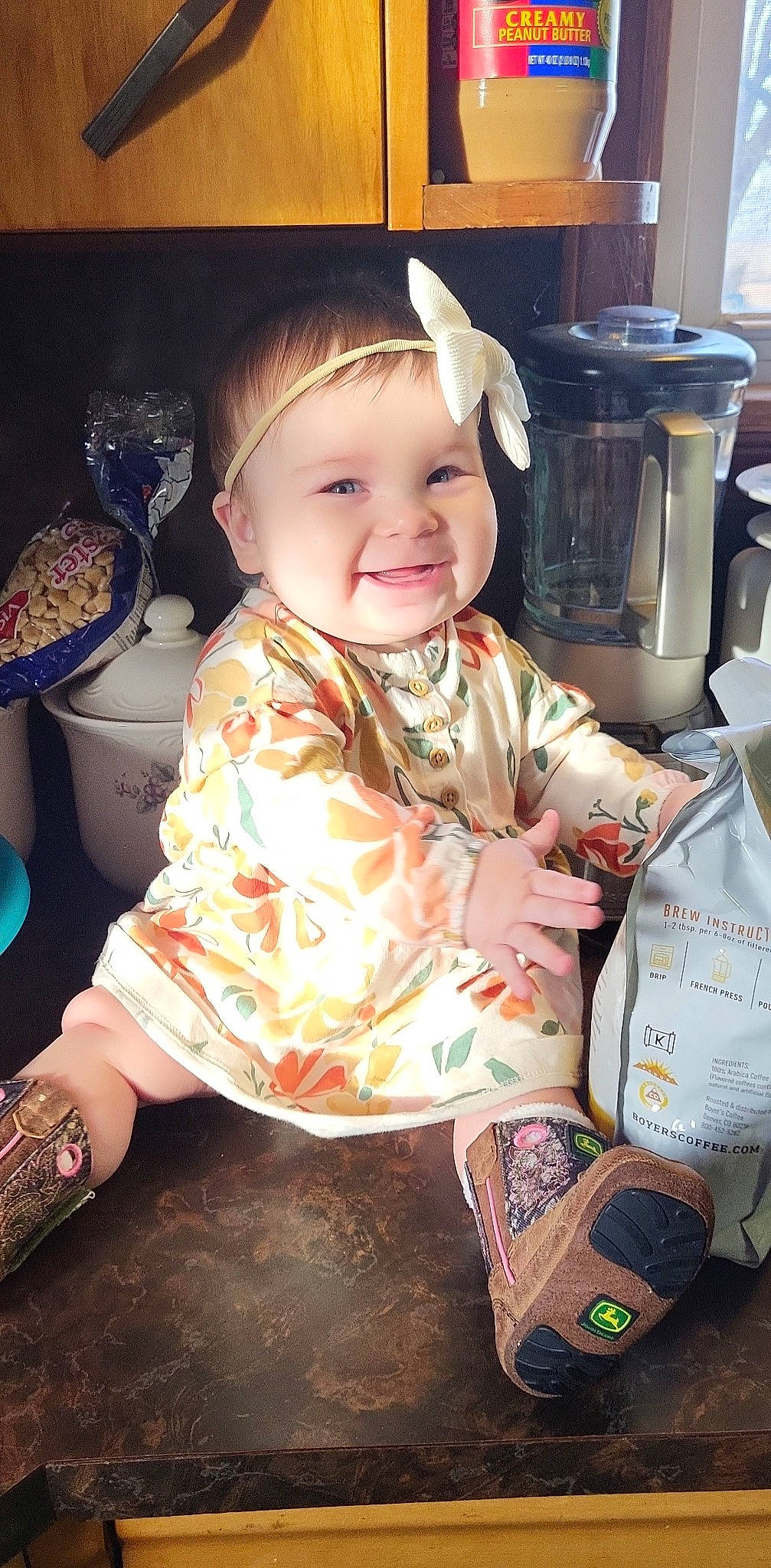 Meredith is registered to the contest to win money with this photo: baby, baby_products, baby_toddler_clothing, cheek, child, cooking, fun, happy, head, home_appliance, human_body, joy, kitchen_appliance, pattern, person, personal_protective_equipment, play, room, sitting, sleeve