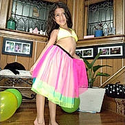 Sophiia Z is registered to the contest to win money with this photo: child, girl, smiling, portrait, fashion, dress, skirt, colorful, rainbow, indoor, home, wooden_wall, window, houseplant, balloon, furniture, barefoot, posing, happy, photography