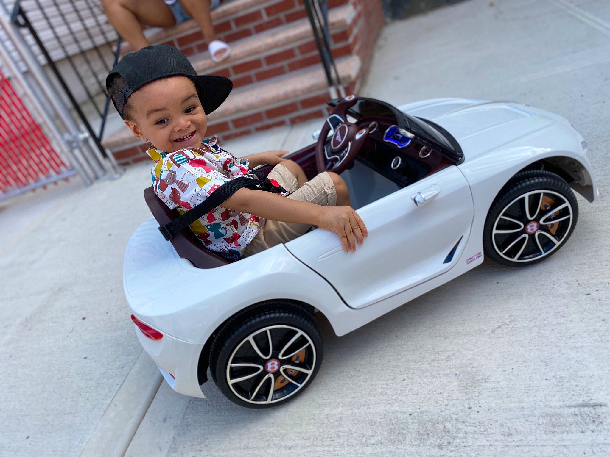 Aiden is registered to the contest to win money with this photo: alloy_wheel, automotive_design, automotive_wheel_system, car, child, headwear, joy, model_car, person, product, rim, sports_car, vehicle, wheel
