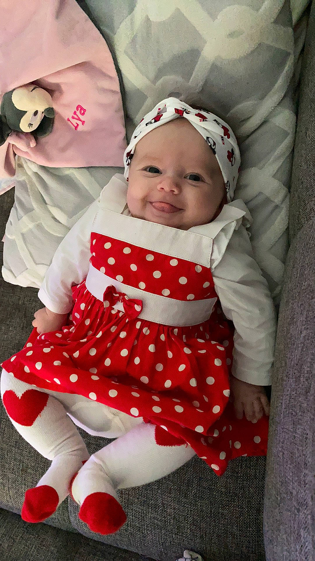 Lya participe au concours pour gagner de l'argent avec cette photo : baby, baby_toddler_clothing, cap, child, comfort, design, dress, event, happy, headwear, pattern, person, pink, red, sleeve, smile, sock, t_shirt, textile, thigh